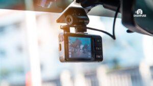 Dash camera installed discreetly inside a car, positioned behind the rear-view mirror